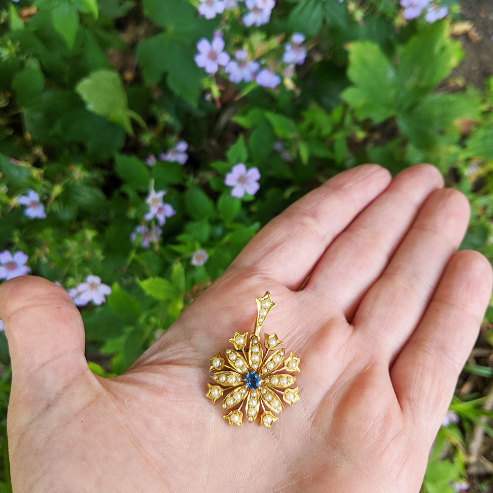 antique brooch in hand for scale