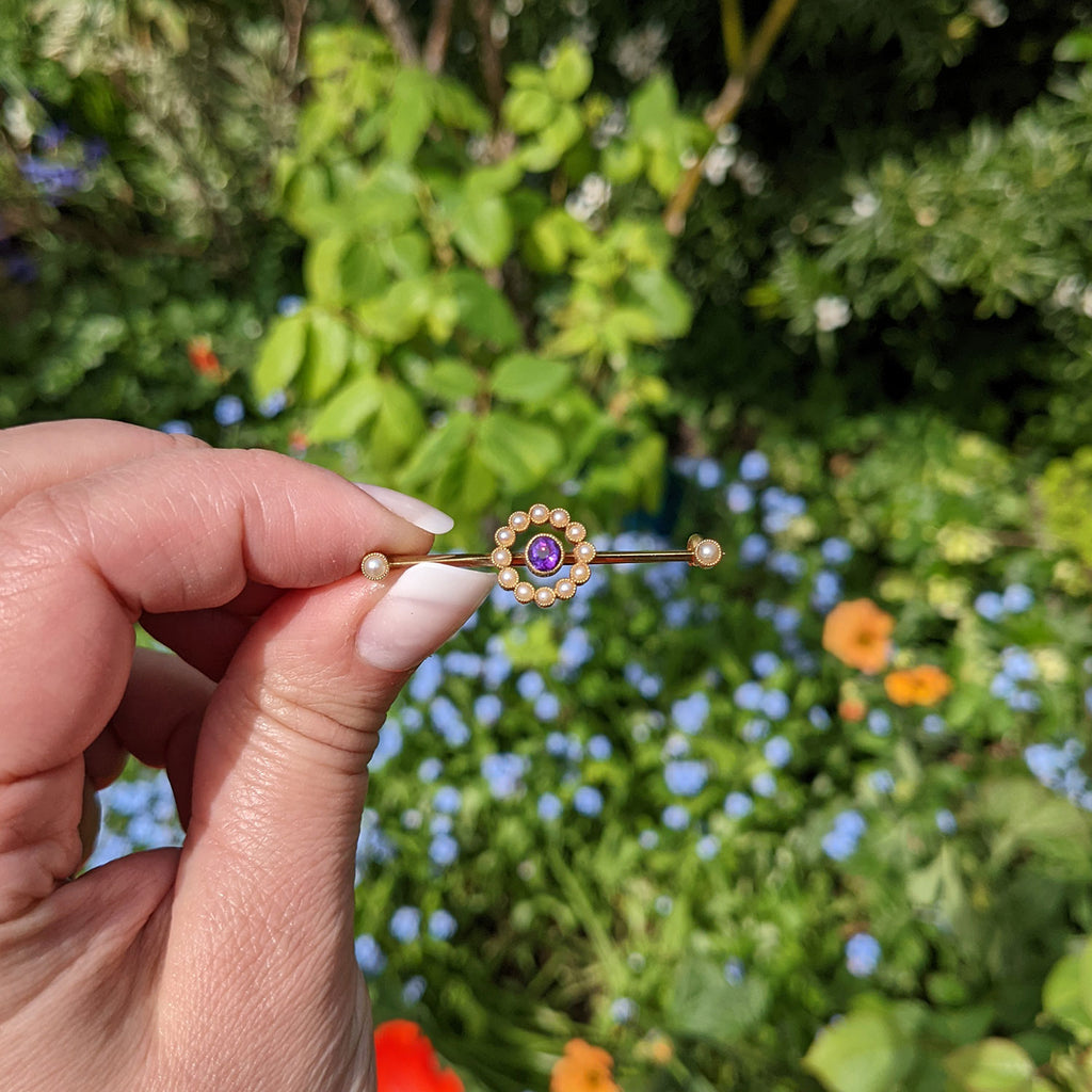 vintage gold brooch in hand for scale